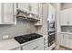 Close-up of a well-equipped kitchen with stainless steel appliances and sleek white cabinetry at 2511 N Grady Ave # 23, Tampa, FL 33607