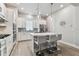 Modern kitchen featuring white cabinets, stainless steel appliances, an island, and pendant lighting at 2511 N Grady Ave # 23, Tampa, FL 33607