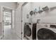 This laundry room has a washer and dryer, plus convenient shelving for storing supplies at 2511 N Grady Ave # 23, Tampa, FL 33607