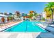 Community pool surrounded by modern buildings and lush palm trees at 2511 N Grady Ave # 23, Tampa, FL 33607