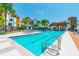 Community pool with modern buildings and lush landscaping surrounding the deck at 2511 N Grady Ave # 23, Tampa, FL 33607