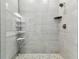 Walk-in shower with gray subway tile, rainfall shower head and built-in shelving at 2511 N Grady Ave # 23, Tampa, FL 33607