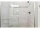 Walk-in shower with glass door and tiled walls with view of vanity at 2511 N Grady Ave # 23, Tampa, FL 33607