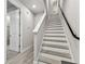 Staircase with wood-look steps and white risers and black handrail at 2511 N Grady Ave # 23, Tampa, FL 33607