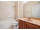 Bathroom featuring a bathtub, toilet and wood vanity at 26914 Juniper Bay Dr, Wesley Chapel, FL 33544