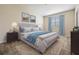 Bedroom with tufted headboard and light blue accents at 26914 Juniper Bay Dr, Wesley Chapel, FL 33544