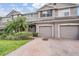 Two-story townhome with two-car garage and landscaped front yard at 26914 Juniper Bay Dr, Wesley Chapel, FL 33544