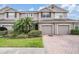 Two-story townhome with two-car garage and landscaped front yard at 26914 Juniper Bay Dr, Wesley Chapel, FL 33544