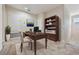 Home office with built-in shelving and hardwood desk at 26914 Juniper Bay Dr, Wesley Chapel, FL 33544