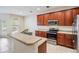 Kitchen with stainless steel appliances and wood cabinets at 26914 Juniper Bay Dr, Wesley Chapel, FL 33544