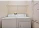 Laundry room with washer, dryer and shelving at 26914 Juniper Bay Dr, Wesley Chapel, FL 33544