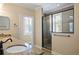 Bathroom showcases a glass shower enclosure with granite countertops and a bright window with shutters at 3107 W Palmira Ave, Tampa, FL 33629