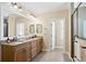 Bright bathroom featuring double sinks, granite countertops, framed mirrors, and a glass-enclosed shower at 3107 W Palmira Ave, Tampa, FL 33629