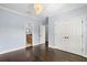 Bedroom featuring hardwood floors, a modern chandelier, and ensuite bathroom and closet entries at 3107 W Palmira Ave, Tampa, FL 33629