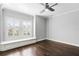 Bedroom featuring hardwood floors, an alcove bench, shutters, and a ceiling fan at 3107 W Palmira Ave, Tampa, FL 33629