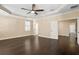 Large bedroom with tray ceilings, hardwood floors, and plantation shutters at 3107 W Palmira Ave, Tampa, FL 33629