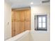 Hallway with built-in storage cabinets and a bright window with shutters at 3107 W Palmira Ave, Tampa, FL 33629