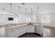 Kitchen island with granite counters, white cabinets, stainless dishwasher, and pendant lighting at 3107 W Palmira Ave, Tampa, FL 33629