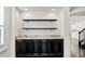 Close up of the living room's built-in shelving and storage with dark hardwood floors at 3107 W Palmira Ave, Tampa, FL 33629