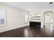 Bright living room features dark hardwood floors, built in shelving, and views of backyard at 3107 W Palmira Ave, Tampa, FL 33629