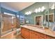 Double vanity bathroom with large shower and granite countertop at 314 Bluewater Falls Ct, Apollo Beach, FL 33572