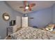 Bedroom with ceiling fan, dresser, and access to bathroom at 314 Bluewater Falls Ct, Apollo Beach, FL 33572