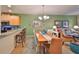 Charming dining area with wooden table and wicker chairs at 314 Bluewater Falls Ct, Apollo Beach, FL 33572