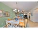 Elegant dining room features a wood table and stylish chandelier at 314 Bluewater Falls Ct, Apollo Beach, FL 33572