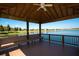 Relaxing gazebo interior with ceiling fan and lake view at 314 Bluewater Falls Ct, Apollo Beach, FL 33572