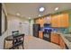 Modern kitchen with granite countertops and wood cabinets at 314 Bluewater Falls Ct, Apollo Beach, FL 33572