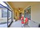 Cozy screened porch with seating for relaxing and enjoying the outdoors at 314 Bluewater Falls Ct, Apollo Beach, FL 33572