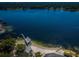 Aerial view of lakefront property with a private beach and dock at 3201 Belmore Rd, Tampa, FL 33618