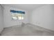 Empty bedroom with window and neutral walls at 3201 Belmore Rd, Tampa, FL 33618