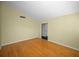 Spacious bedroom with hardwood floors and an adjacent door at 3201 Belmore Rd, Tampa, FL 33618