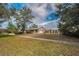 Ranch-style home with brick facade and attached garage, situated on a spacious lot at 3201 Belmore Rd, Tampa, FL 33618