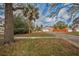 Home with carport and palm tree, located on a quiet street with mature trees at 3201 Belmore Rd, Tampa, FL 33618