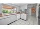 View of kitchen with white cabinets and granite countertops at 3201 Belmore Rd, Tampa, FL 33618