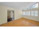 Living room with hardwood floors and large windows with shutters at 3201 Belmore Rd, Tampa, FL 33618