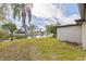 Spacious backyard with canal views and palm trees at 3334 Rock Valley Dr, Holiday, FL 34691