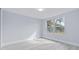 Bright bedroom with large windows and light grey walls at 3334 Rock Valley Dr, Holiday, FL 34691