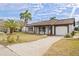 Single story home with a large driveway and mature landscaping at 3334 Rock Valley Dr, Holiday, FL 34691