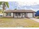 Newly renovated single story home with a landscaped front yard at 3334 Rock Valley Dr, Holiday, FL 34691