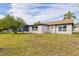 Side view of the house with a spacious yard at 3334 Rock Valley Dr, Holiday, FL 34691