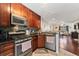 Well-equipped kitchen, featuring dark wood cabinets and stainless steel appliances at 3406 Waterbridge Dr, Tampa, FL 33618