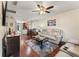 Open living space with hardwood floors, a large TV, and view of kitchen at 3406 Waterbridge Dr, Tampa, FL 33618