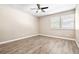 Bedroom with neutral walls, wood-look floors, and ceiling fan at 354 Ixora Dr, Palm Harbor, FL 34684