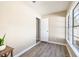 Simple bedroom with neutral walls, wood-look floors, and a window at 354 Ixora Dr, Palm Harbor, FL 34684