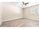 Bright bedroom with neutral walls, wood-look floors, and ceiling fan at 354 Ixora Dr, Palm Harbor, FL 34684