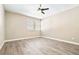 Bedroom with neutral walls, wood-look floors, window, and ceiling fan at 354 Ixora Dr, Palm Harbor, FL 34684