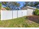 White vinyl fence and gate provide privacy at 354 Ixora Dr, Palm Harbor, FL 34684